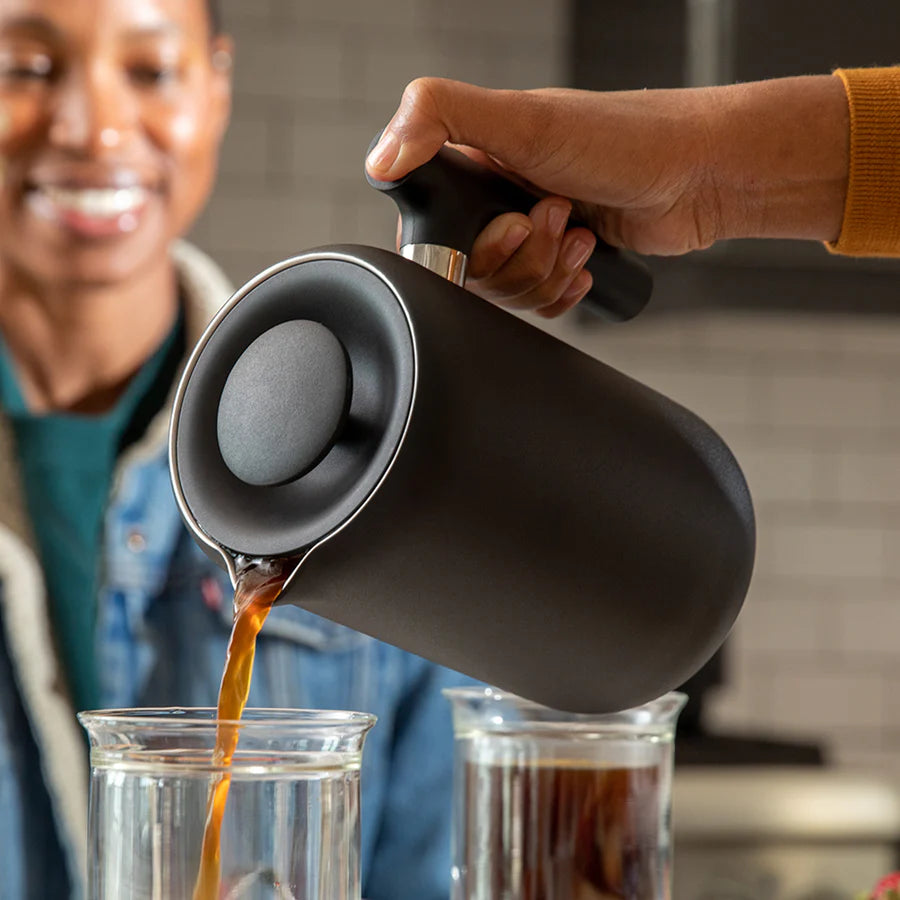 Fellow Clara French Press in Matte Black  pouring coffee into tasting glasses